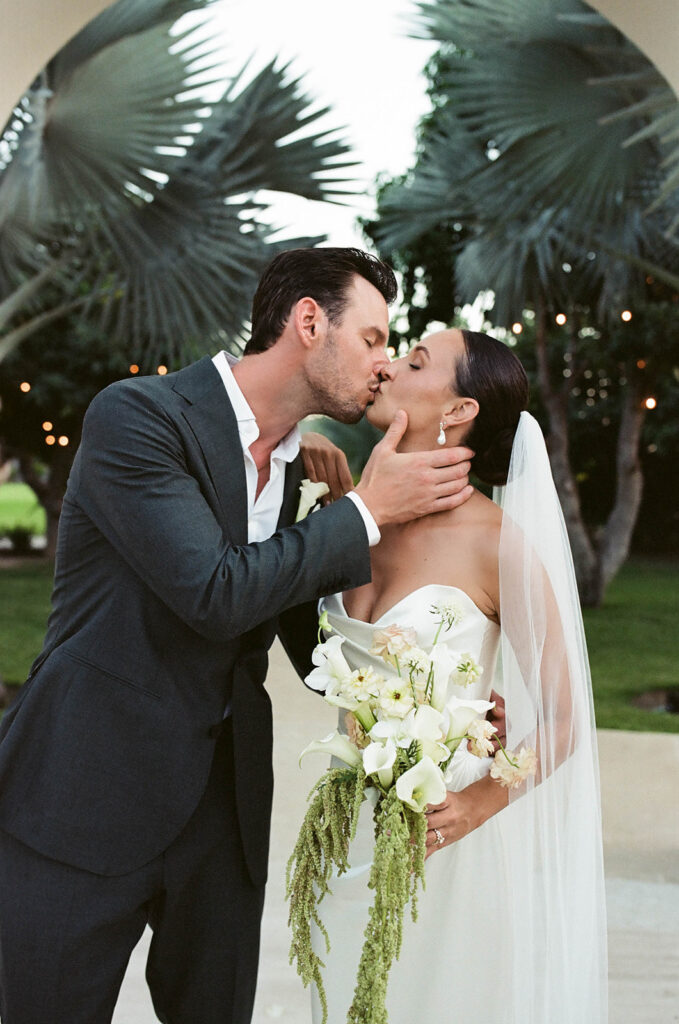 bride and groom kissing during their cabo wedding in baja luna