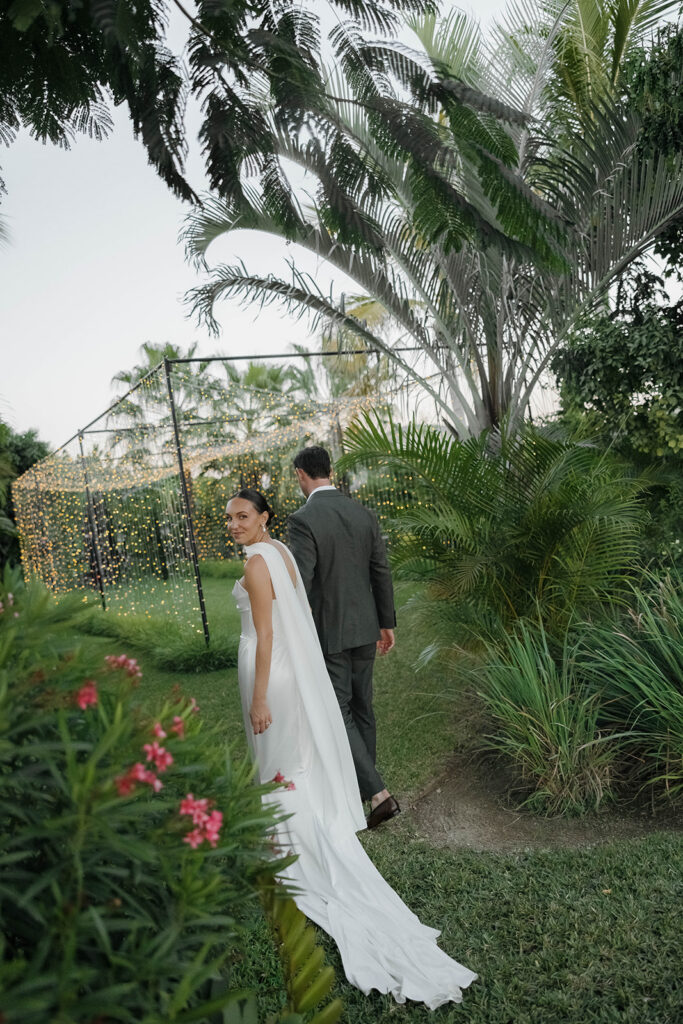 bride and groom wandering the grounds during their cabo wedding at baja luna
