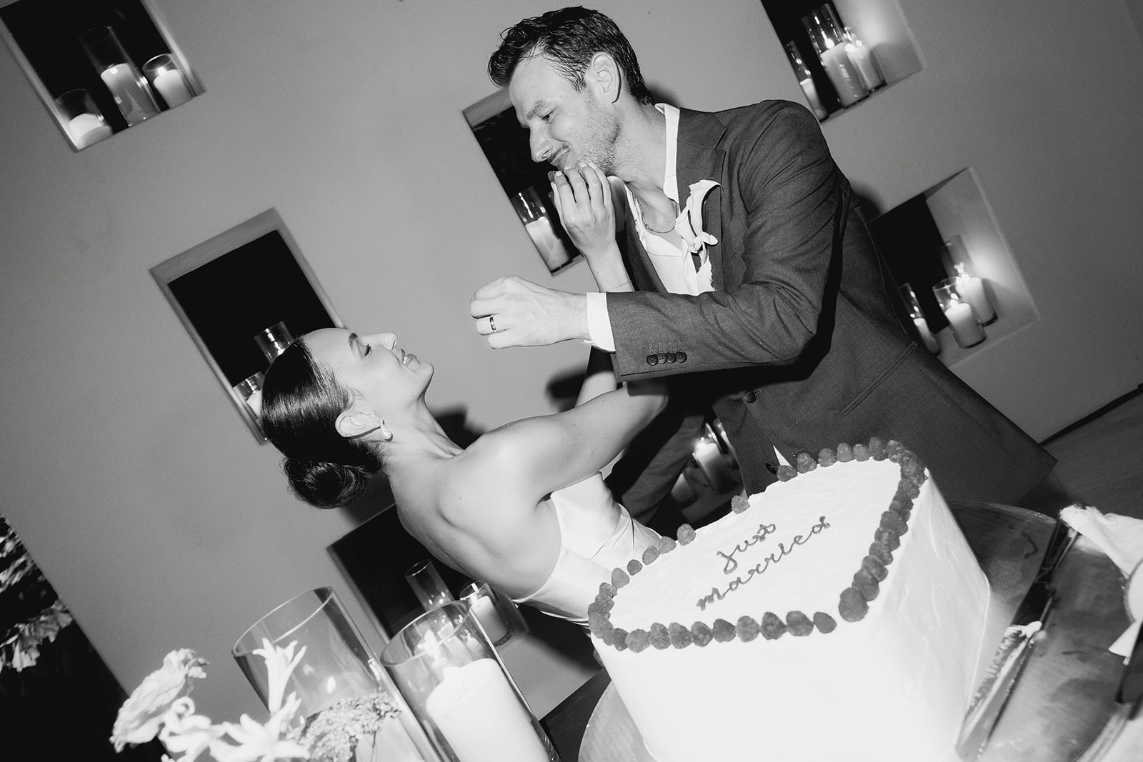 bride and groom feeding each other cake