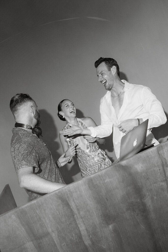 bride and groom at the dj booth during their wedding reception