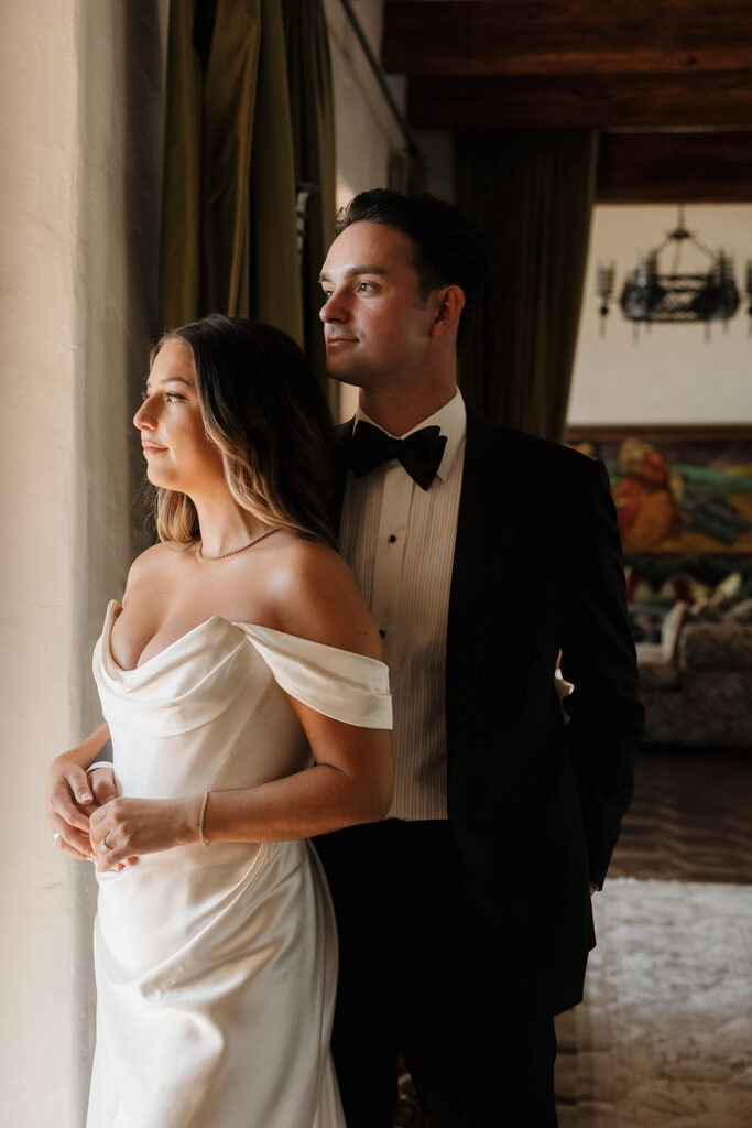 bride and groom taking photos inside the elegant rooms at the hummingbird nest ranch