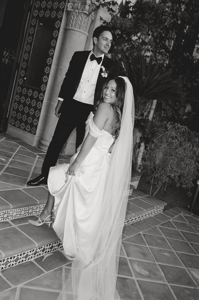 bride and groom posing in front of their spanish villa inspired wedding venue - hummingbird nest ranch in California