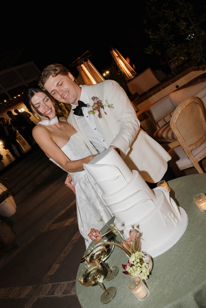 bride and groom cutting cake