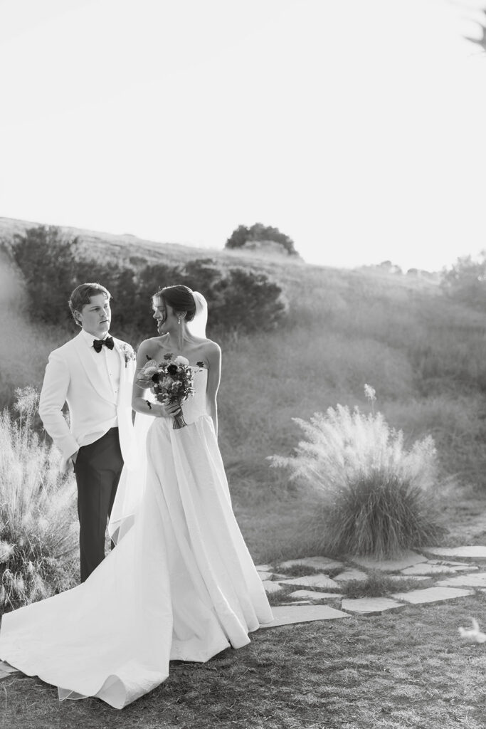 elegant bride and groom in the gardens at jeune perche, a european inspired wedding venue in california