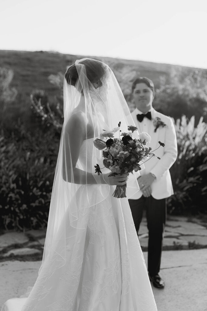 elegant bride and groom in the gardens at jeune perche, a european inspired wedding venue in california