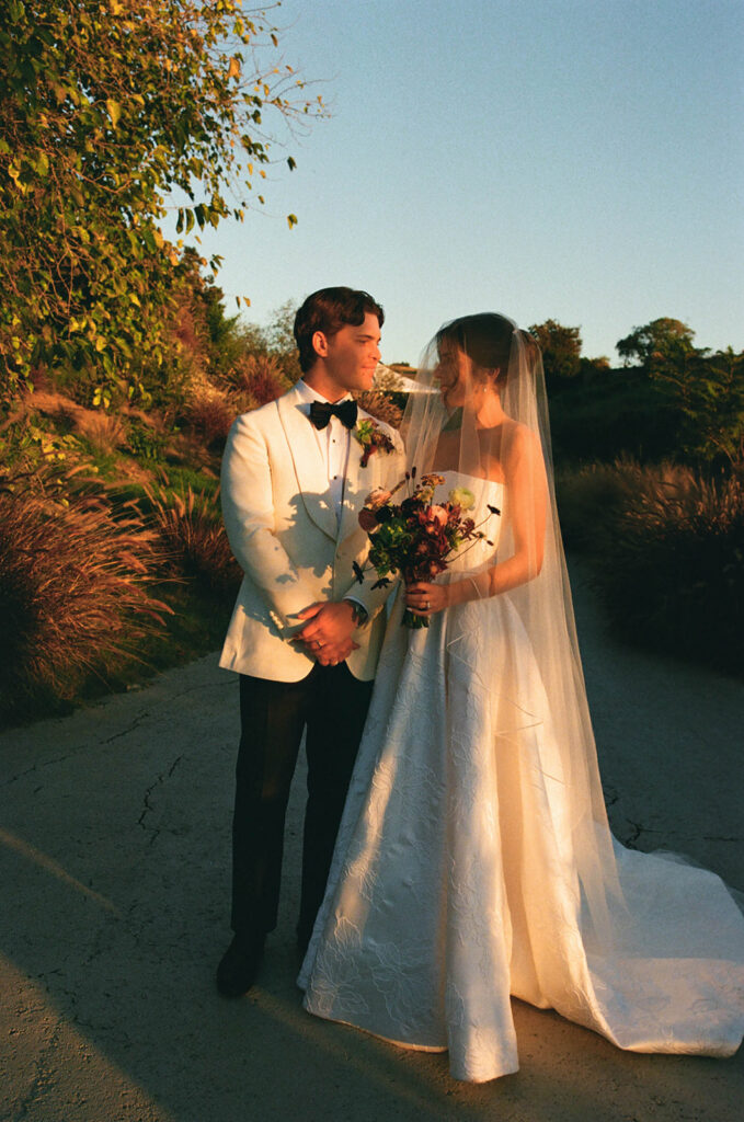 elegant bride and groom in the gardens at jeune perche, a european inspired wedding venue in california