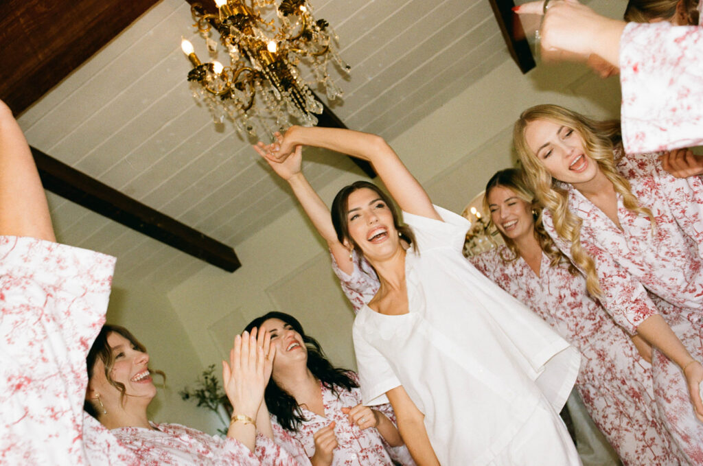 bride and bridesmaids getting ready in cute pijamas
