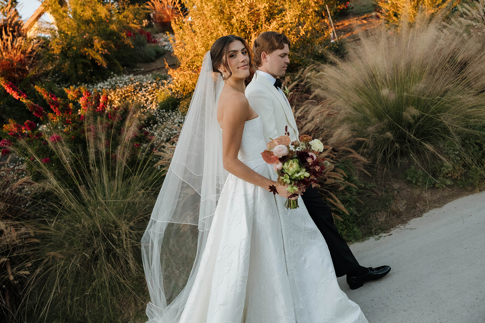 elegant bride and groom in the gardens at jeune perche, a european inspired wedding venue in california