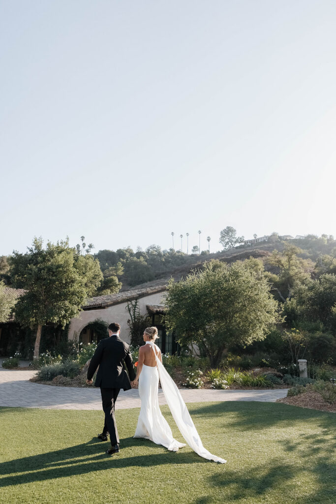 bride and groom walking in front of the Monserate winery wedding venue