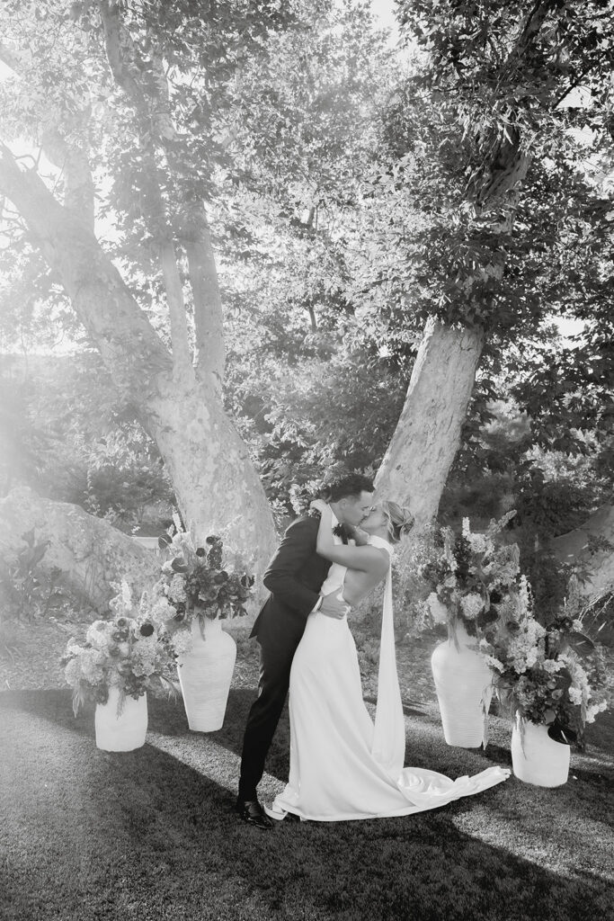 bride and groom kissing at the ceremony tree during their Monserate winery wedding