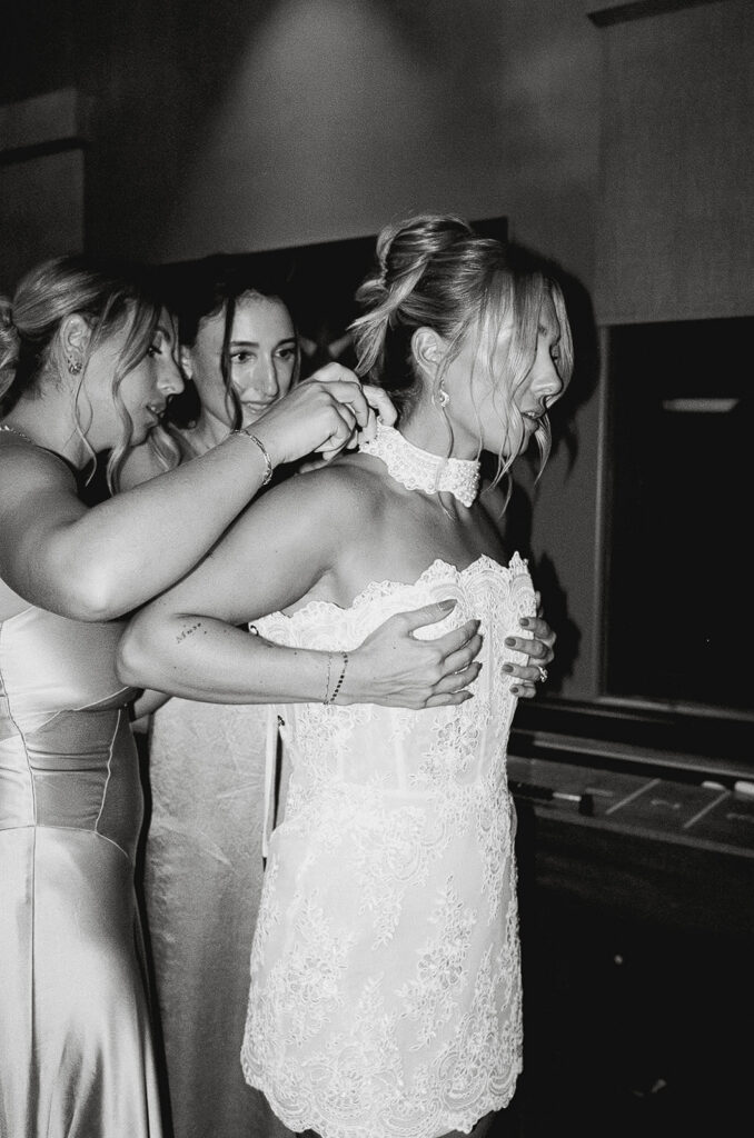 bride changing into a short wedding reception dress