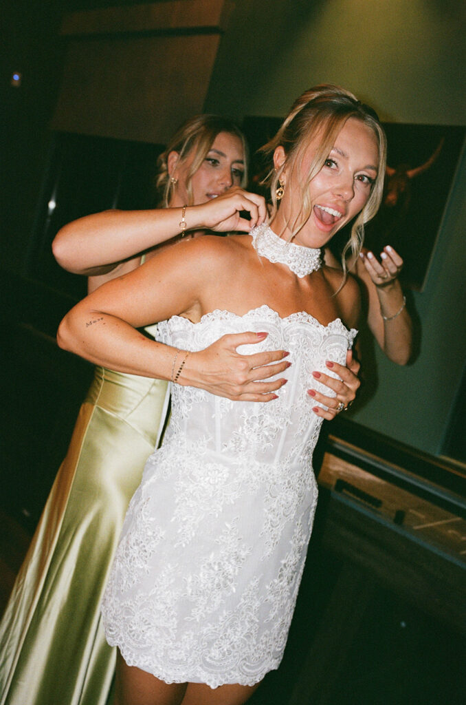 bride changing into a short wedding reception dress