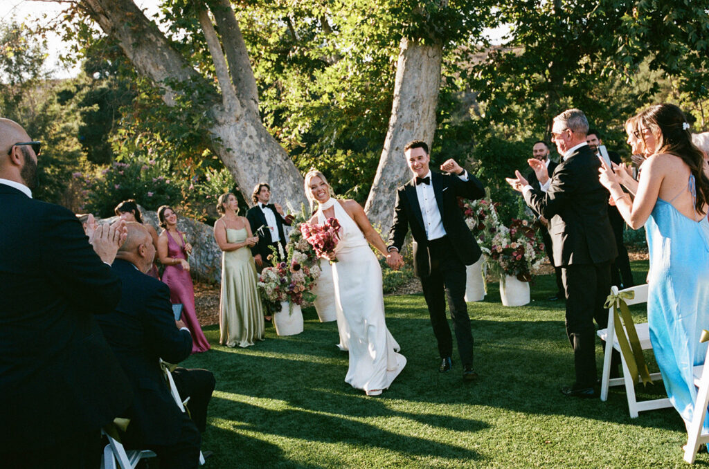 joyful bride and groom wedding ceremony exit moment