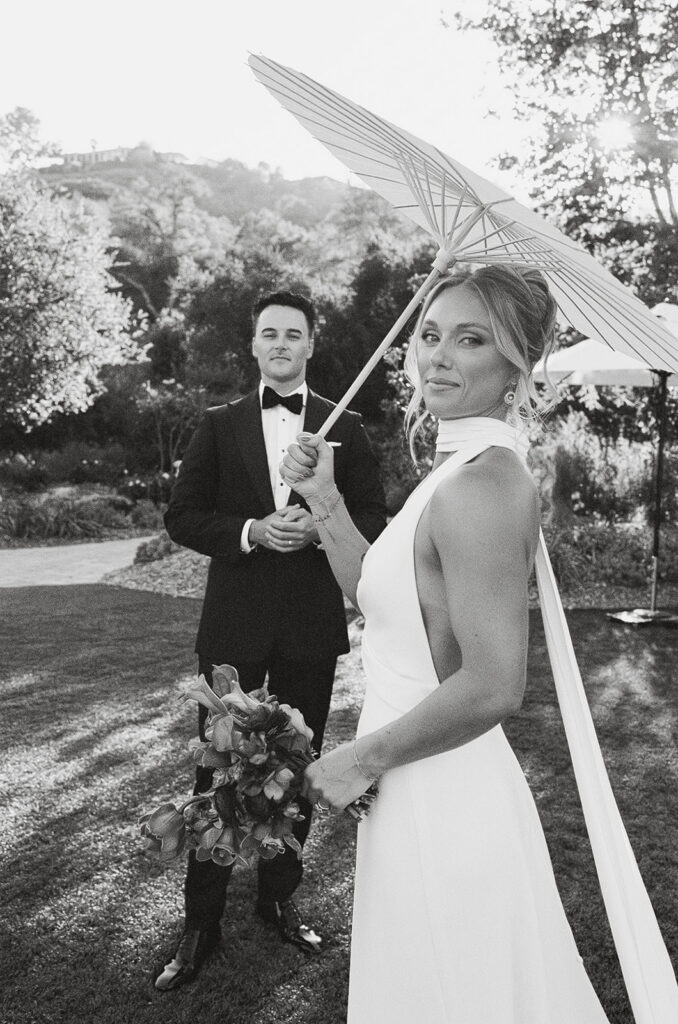 bride and groom posing at the lush grounds of Monserate winery during their wedding day