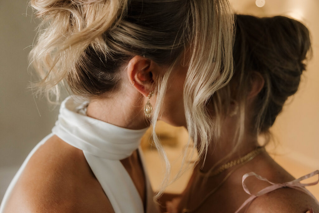 mom helping bride get ready at a clean getting ready suite