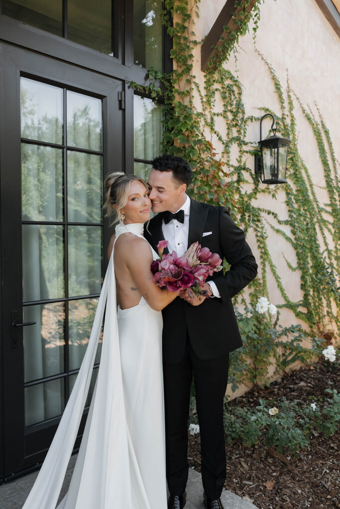 bride and groom snuggling in front of the Monserate winery wedding venue