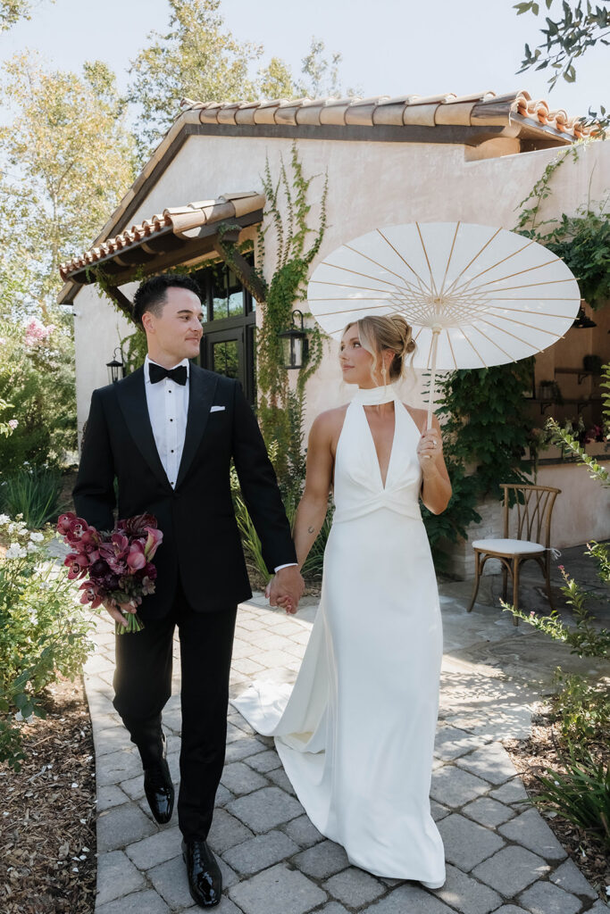bride and groom roaming around the lush grounds of Monserate winery