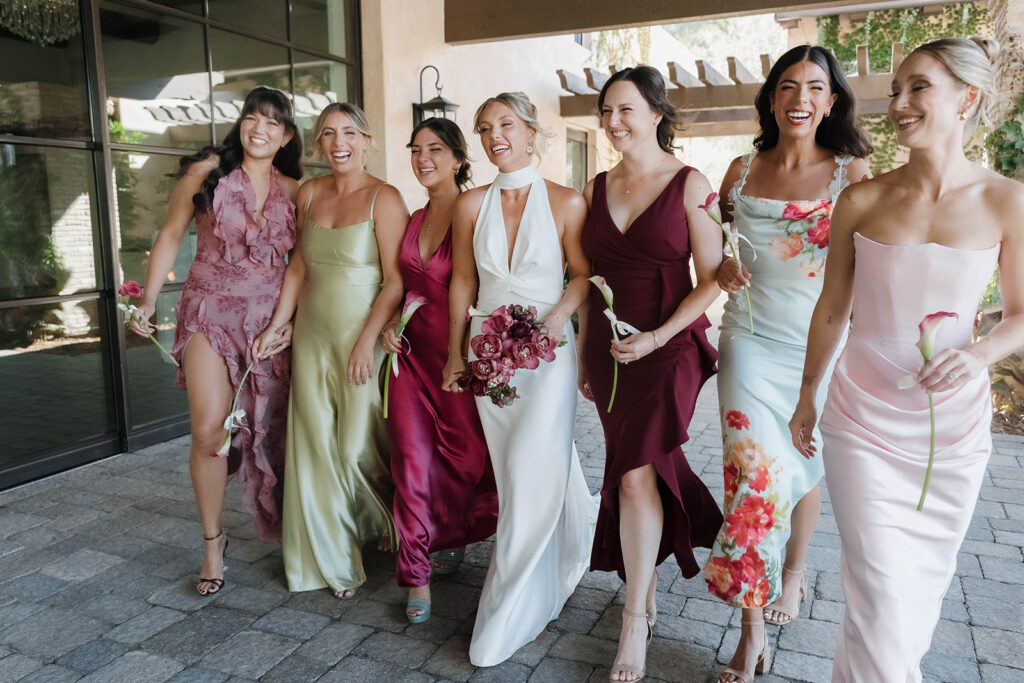 bride and bridesmaids in mismatched dresses