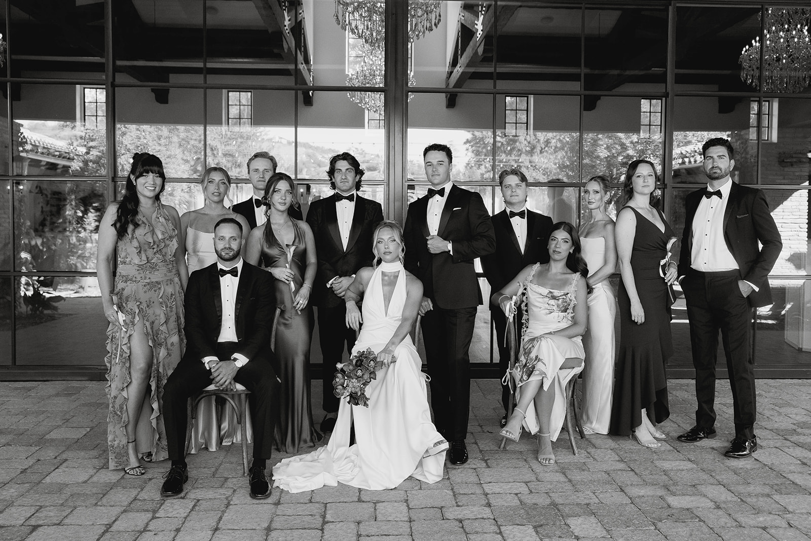 bride and groom posing with their wedding party