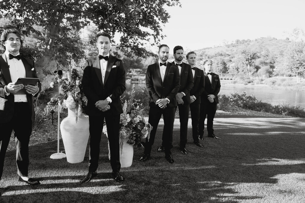 groom and groomsmen waiting at the altar
