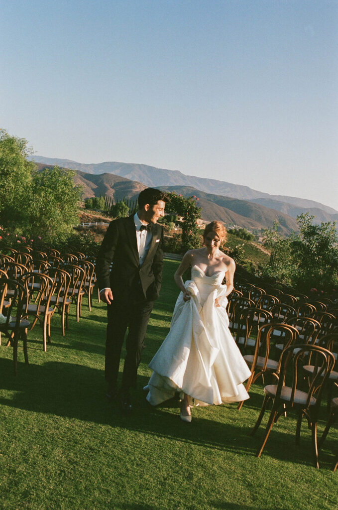 bride and groom walking through their wedding ceremony space at the Morgan Estate wedding venue
