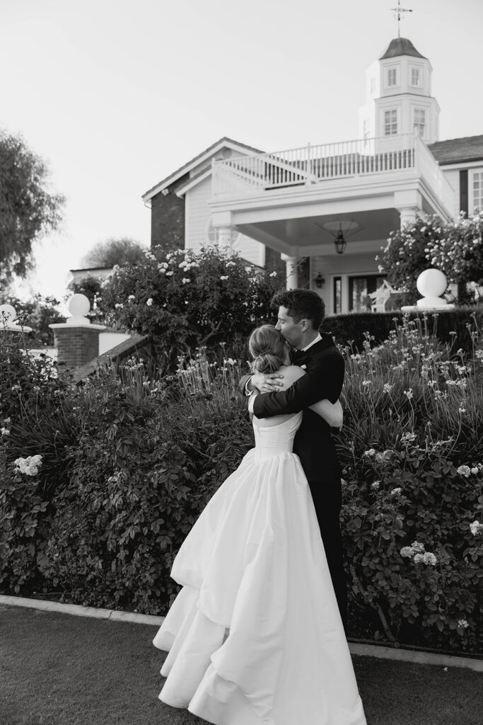 bride and groom kissing in front of their morgan estate wedding venue