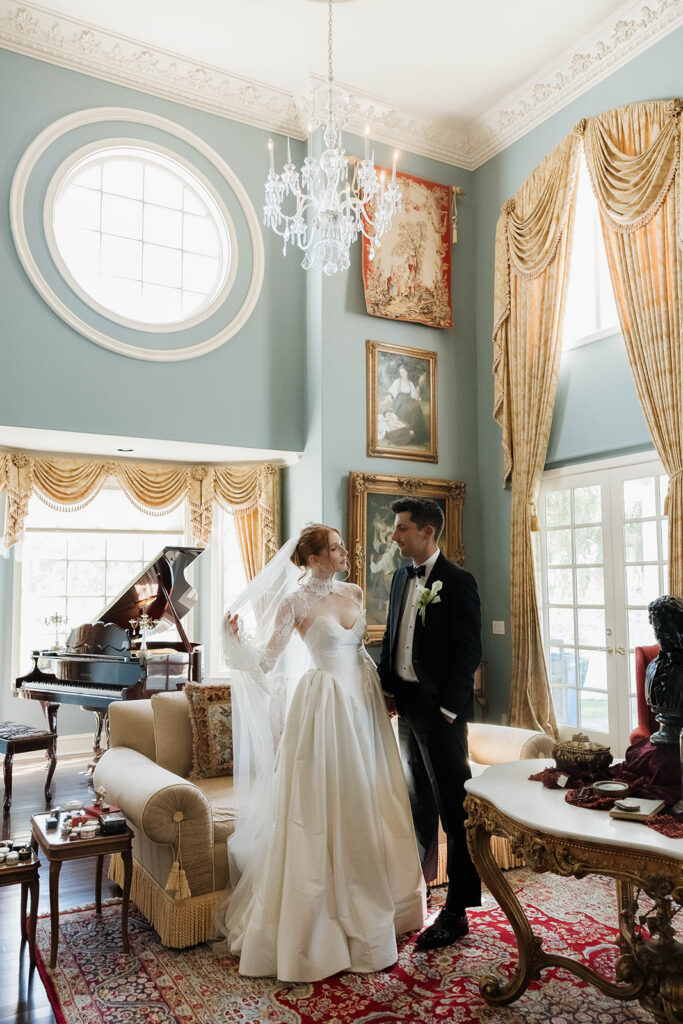 bride and groom posing inside the luxurious rooms of Morgan Estate