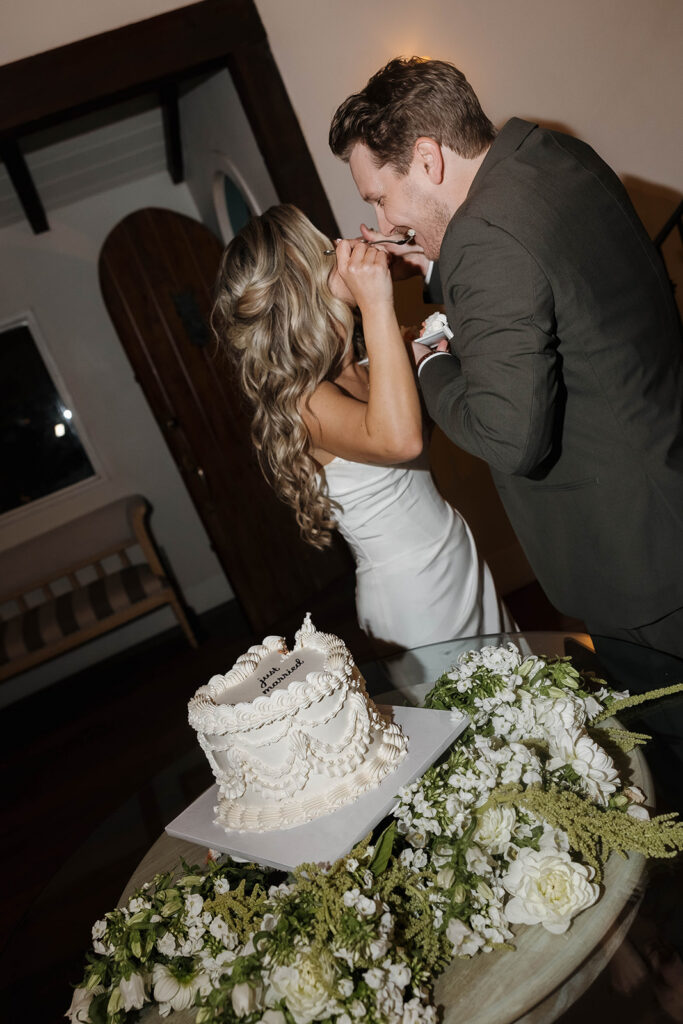 bride and groom cutting cake