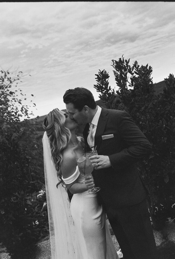 wedding couple kissing during their california estate wedding at jeune perche