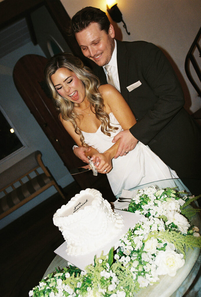bride and groom cutting cake
