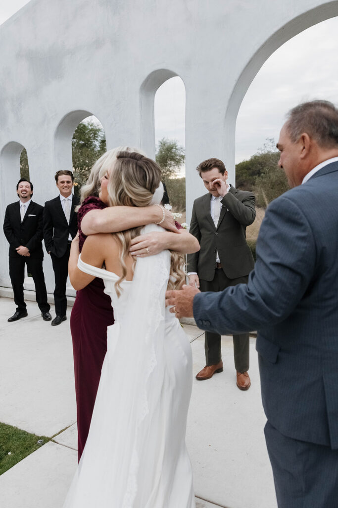 mom and dad giving the bride away at the altar