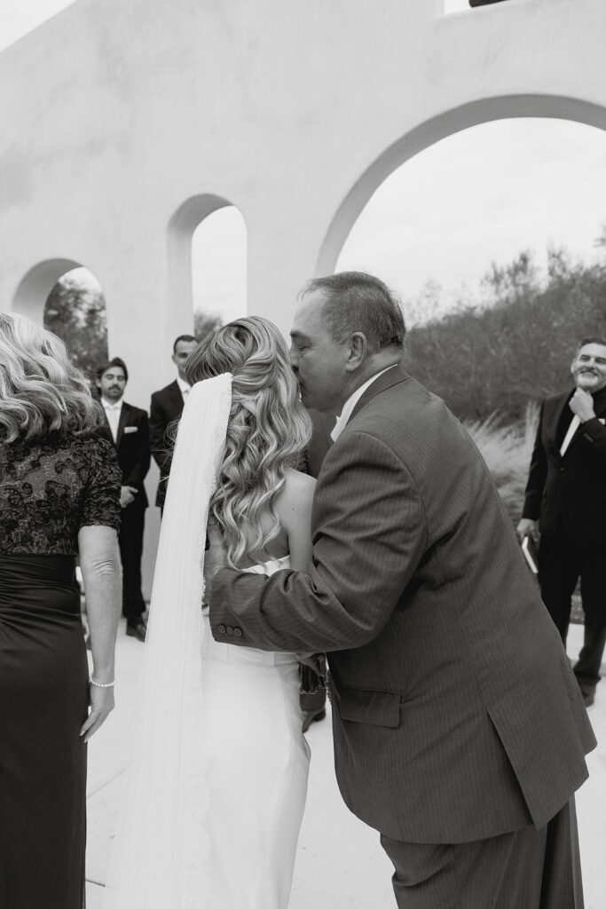 mom and dad giving the bride away at the altar