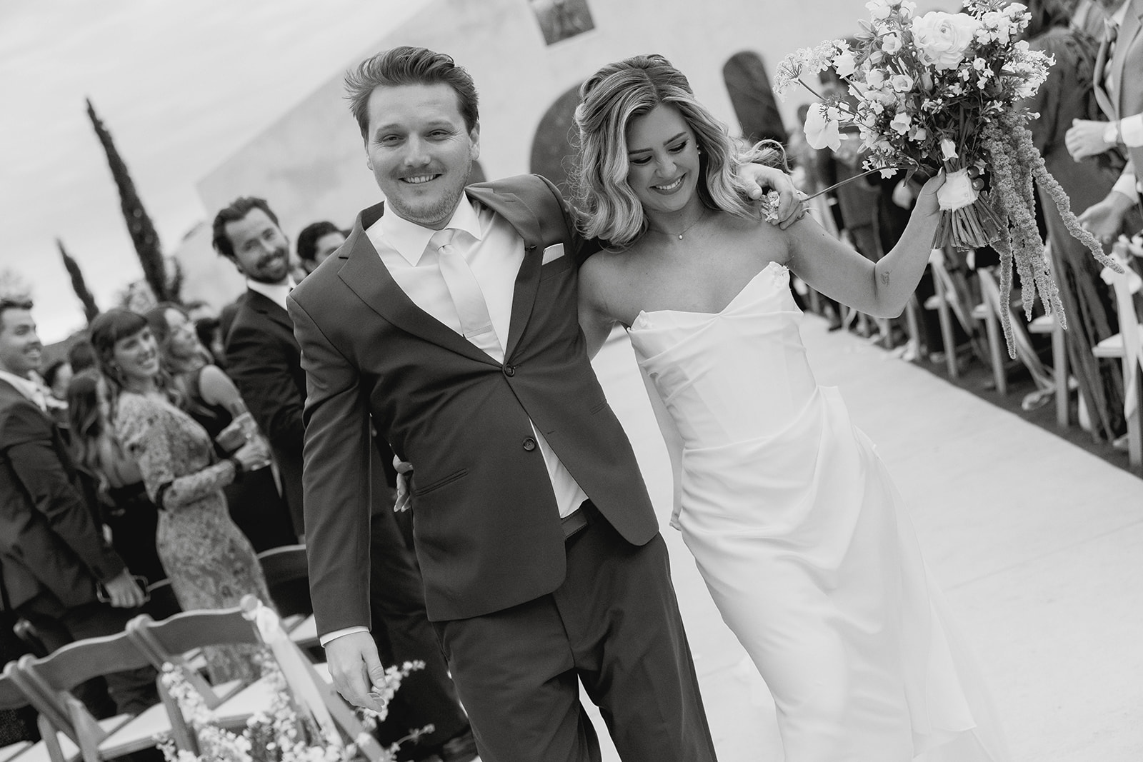 joyful bride and groom wedding ceremony exit