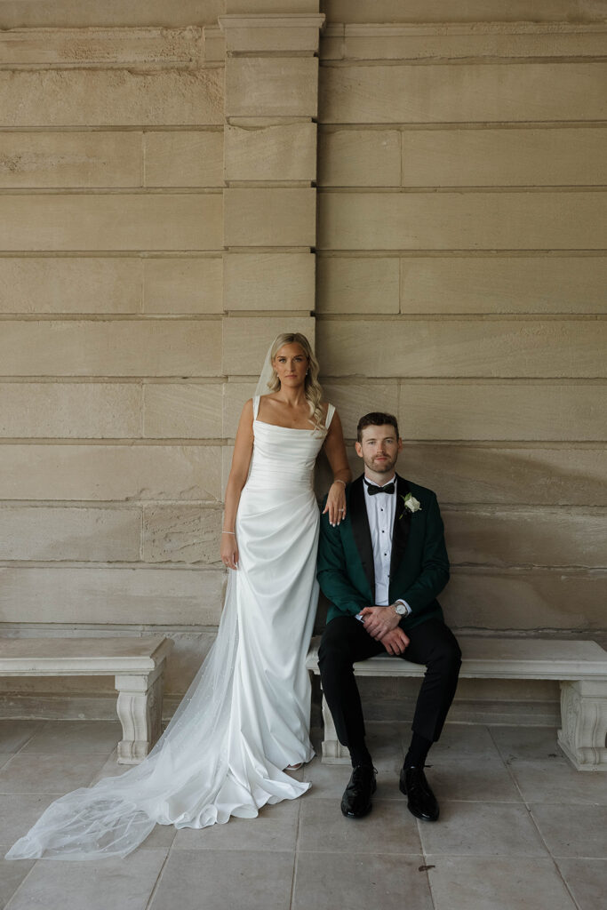 bride and groom posing in front of stone manor in lake geneva, wisconsin