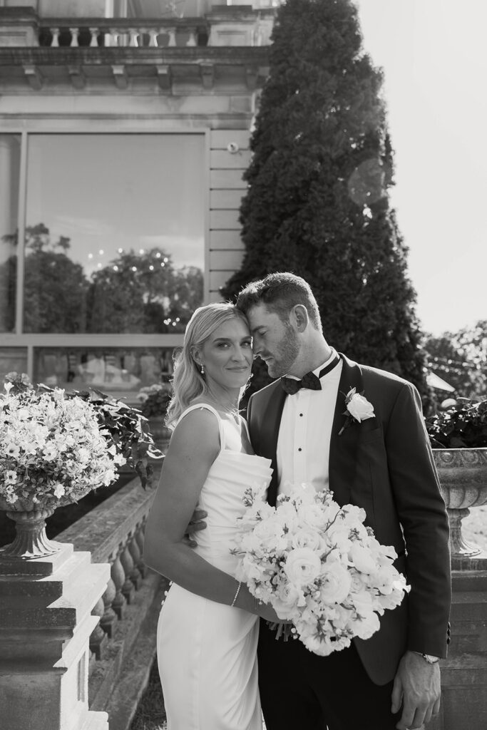 bride and groom hugging in front of stone manor in lake geneva, wisconsin