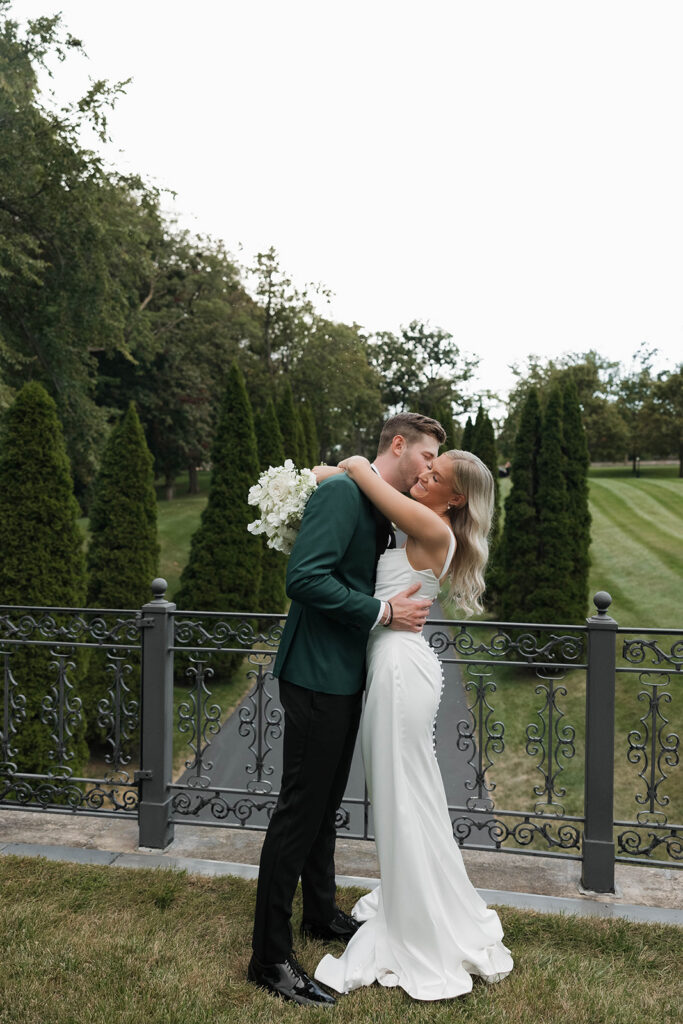bride and groom hugging in the lush grounds at stone manor in lake geneva, wisconsin