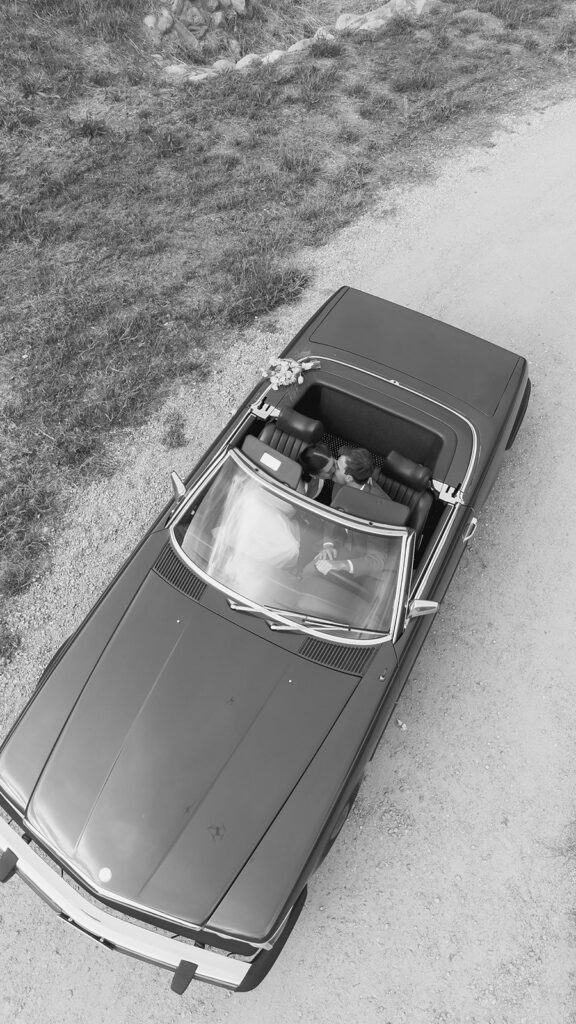 bride and groom posing with a vintage car during their ojai wedding