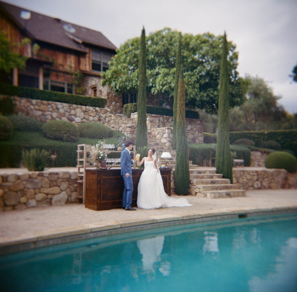 bride and groom at the poolside of olive branch ranch