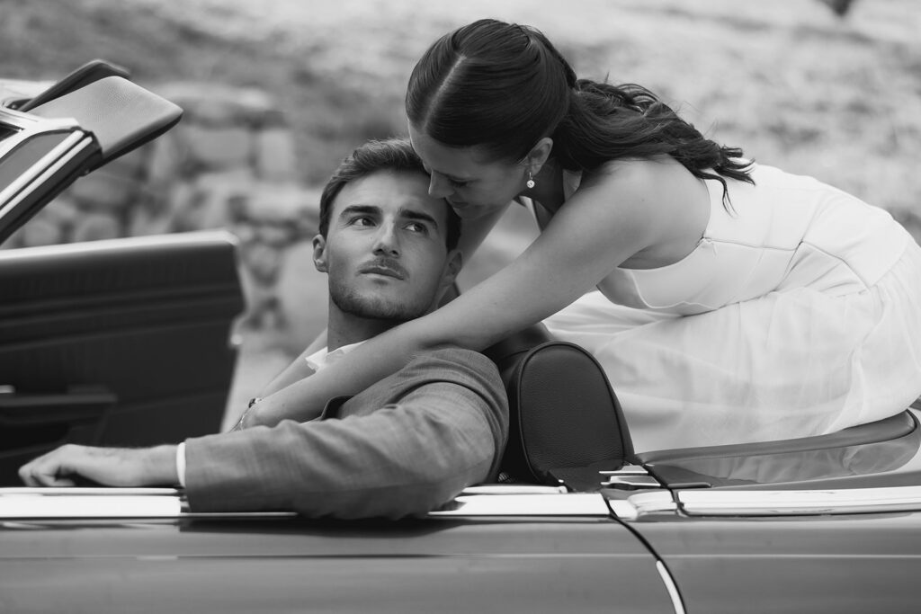 bride and groom posing with a vintage car during their ojai wedding