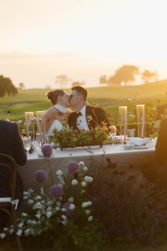 bride and groom kissing during wedding reception