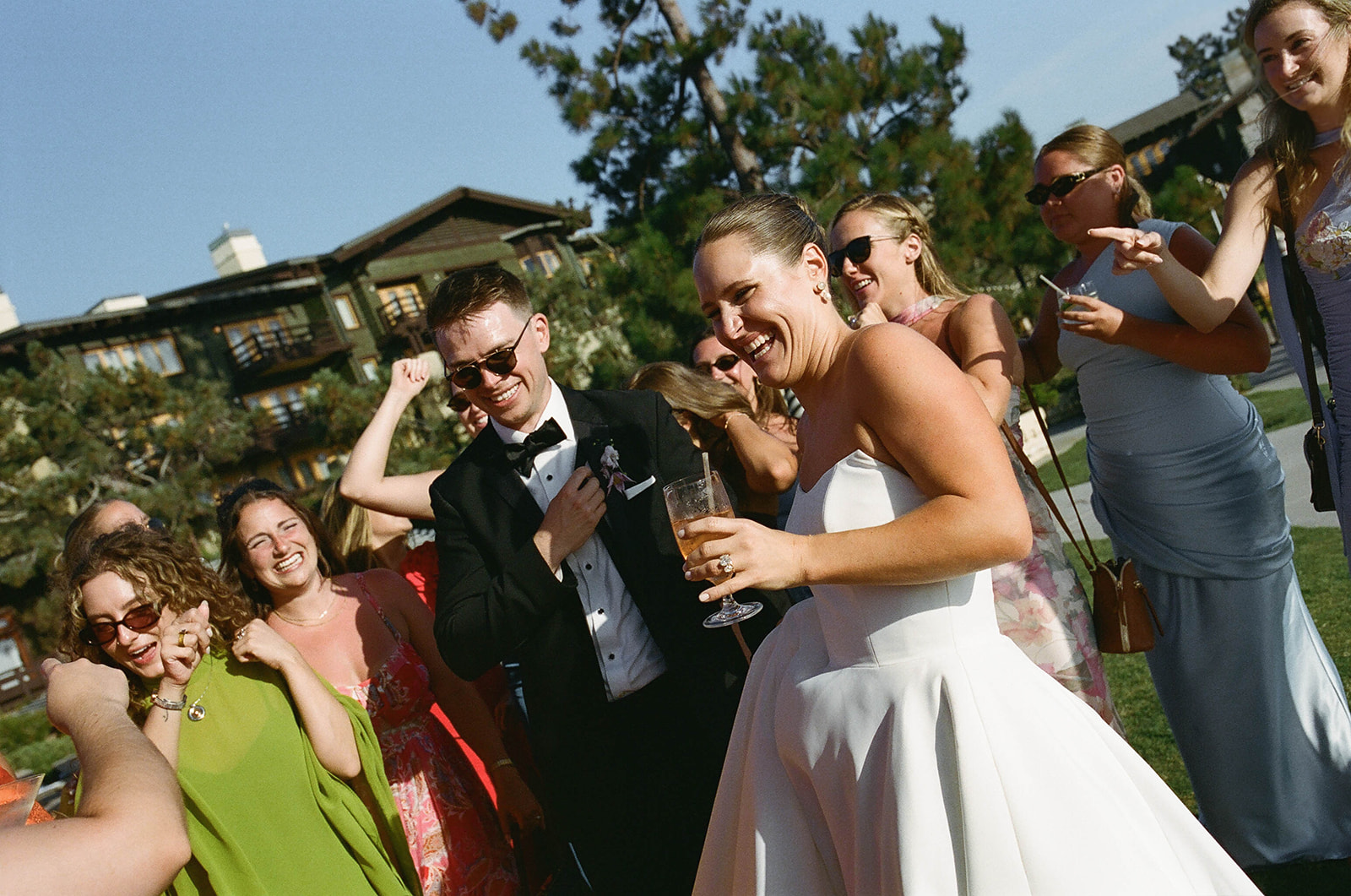 joyful bride and groom and their wedding party