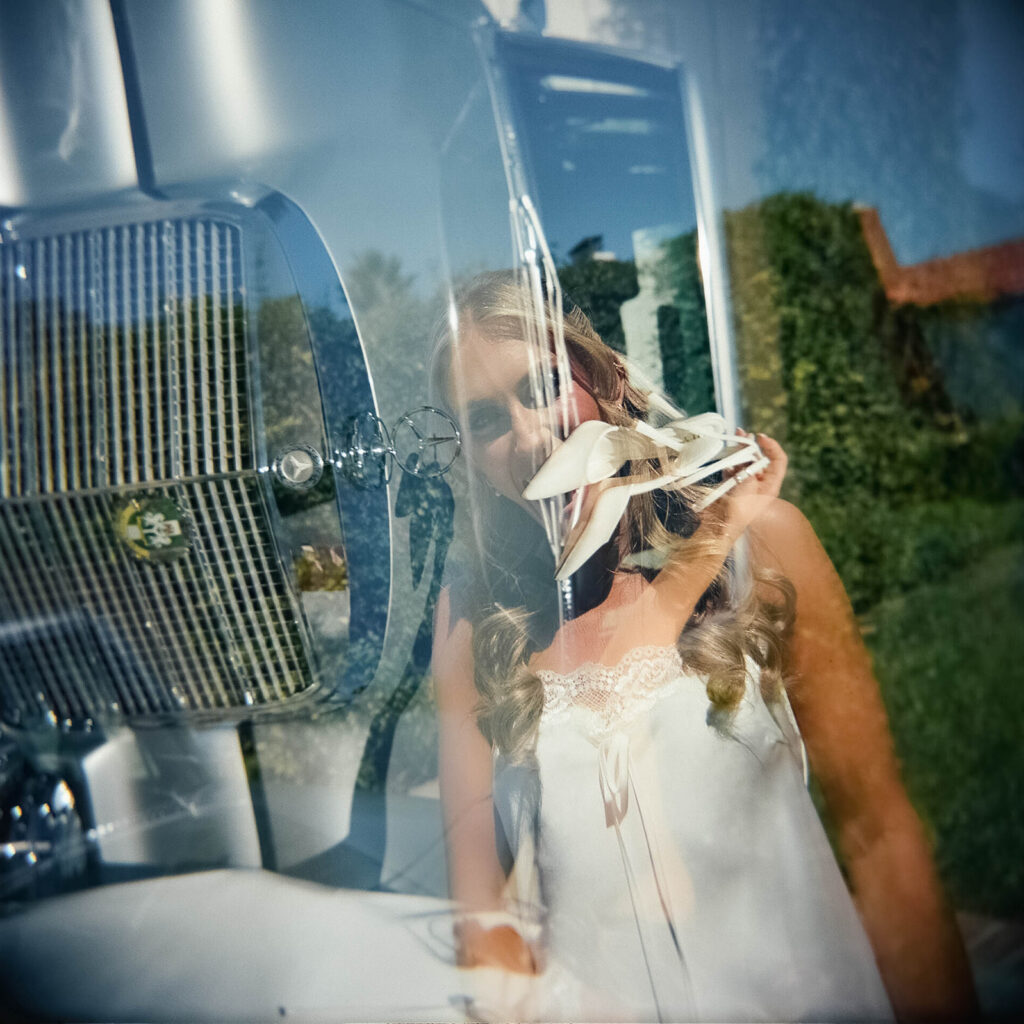 candid bridal portraits in front of a vintage car