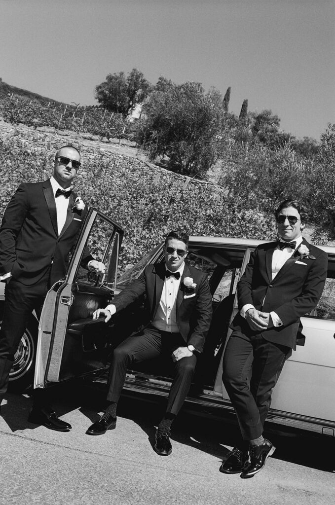 groom and groomsmen at a vintage car