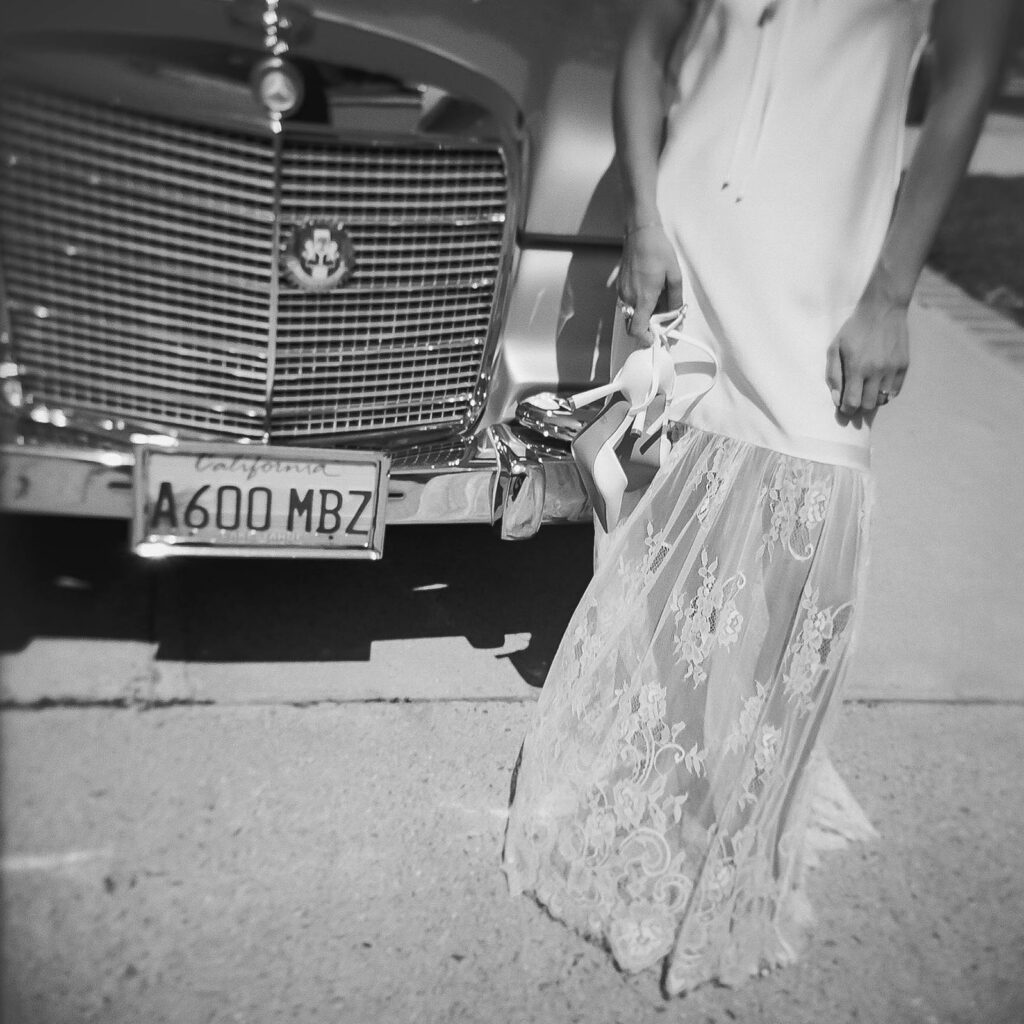 candid bridal portraits in front of a vintage car