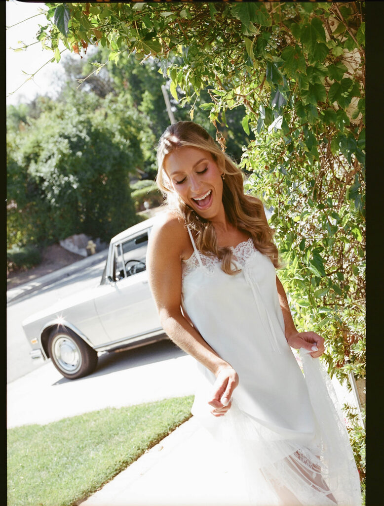 candid bridal portraits in front of a vintage car