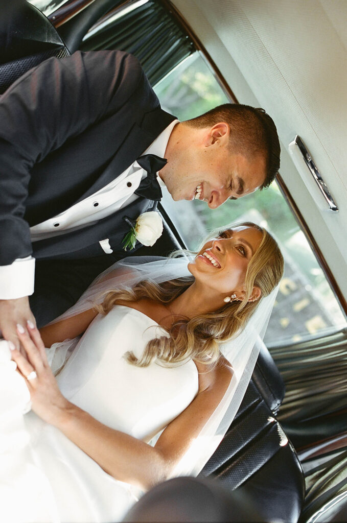 smiley bride and groom in a vintage car during their malibu wedding day at cielo farms